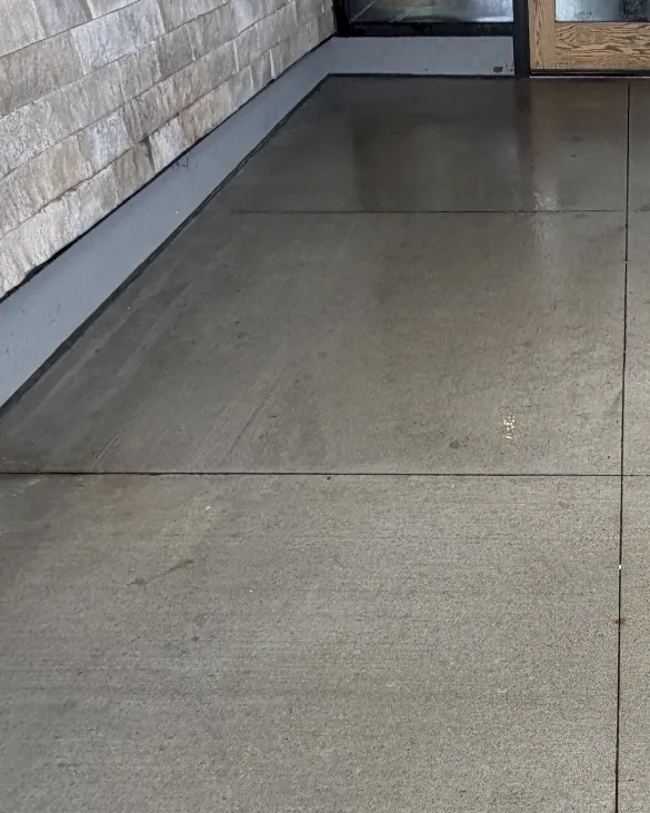 After: The same commercial sidewalk clean after gum removal and pressure washing