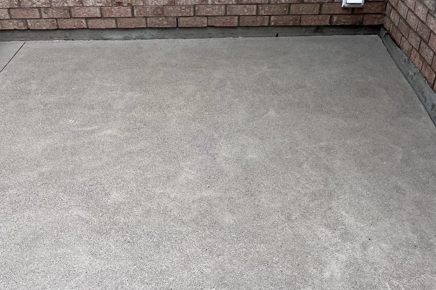 After: The same concrete pad evenly clean after pressure washing