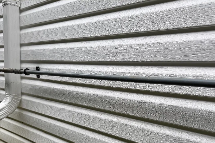 After: The same siding corner bright and clean after a house soft wash